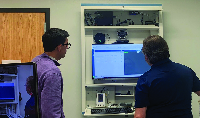 Superintendent Jeremy Bussey watches as a technician demonstrates the new telehealth station at Hydro-Eakly Public School.

Photo provided by Southwestern Oklahoma State University
